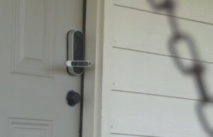 Airbnb en Alabama frena reservas para el Cuatro de Julio Cerradura electrónica inteligente en una puerta blanca de un alquiler vacacional regulado por Airbnb.