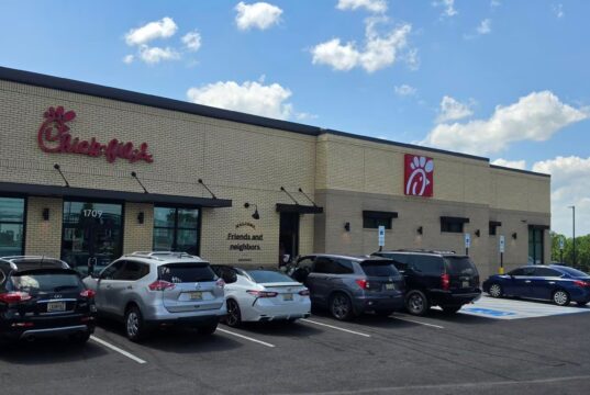 Chick-fil-A en Alabama recauda fondos por ex empleado ahogado Fachada exterior de un restaurante Chick-fil-A en Alabama con vehículos estacionados frente al establecimiento en un día despejado.