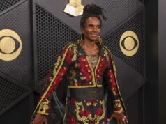 Milli Vanilli: Fab Morvan cancela show con Donald Trump El cantante Fab Morvan posa sonriente en una alfombra roja con un traje negro y rojo bordado.