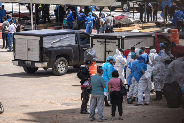 Personal médico y familiares junto a unidades de traslado en la morgue improvisada tras el terremoto en Venezuela.