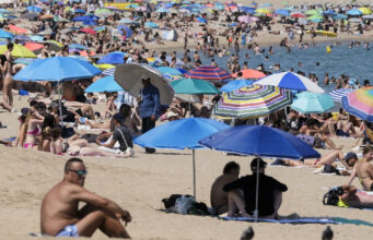 Ola de calor en Europa deja miles de muertos por temperaturas extremas Playa repleta de personas bajo sombrillas de colores para protegerse de la intensa ola de calor en Europa.