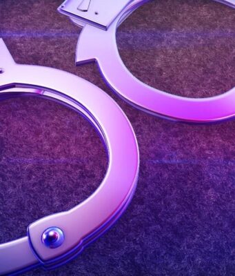 Arrestos en Alabama por red de contrabando en prisiones Esposas de metal iluminadas con luz violeta representativas del arresto por contrabando en prisiones.