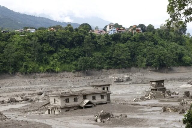 nepal-china-riada-casas-sepultadas-lodo Viviendas destruidas y sepultadas por lodo tras una riada en la región fronteriza del Himalaya entre Nepal y China.