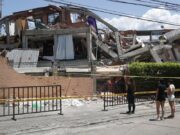 Terremoto en Colombia deja 281 muertos y 379 desaparecidos Personas observando la estructura colapsada de un edificio destruido por el terremoto en Colombia.